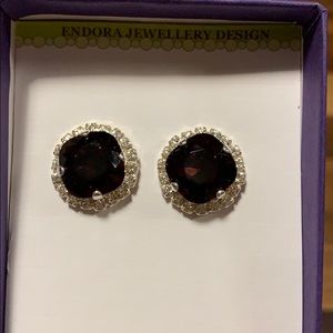 Dark ruby stoned earrings with diamond accent halo